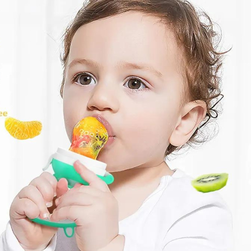Bébé mangeant des fruits frais avec grignoteuse sécuritaire"